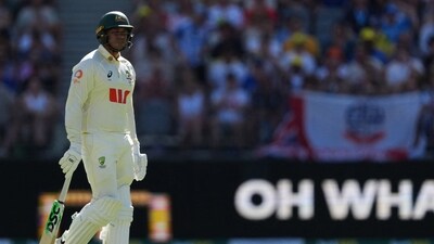Usman Khawaja looks dejected and walks back to the pavilion after losing his wicket. (REUTERS)