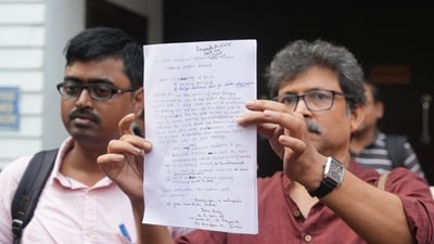 A Booth Level Officers (BLO) shows a letter being sent to the Election Commission of India (ECI) as BLOs protest demanding official duty status and security cover. (PTI) A Booth Level Officers (BLO) shows a letter being sent to the Election Commission of India (ECI) as BLOs protest demanding official duty status and security cover. (PTI)
