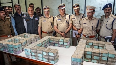 Bengaluru City Police Commissioner Seemant Kumar Singh and other senior officials pose for photographs with recovered cash in connection with the ₹7.11 crore robbery in the city, in Bengaluru, Karnataka, Saturday, Nov. 22, 2025. (PTI) Bengaluru City Police Commissioner Seemant Kumar Singh and other senior officials pose for photographs with recovered cash in connection with the ₹7.11 crore robbery in the city, in Bengaluru, Karnataka, Saturday, Nov. 22, 2025. (PTI)