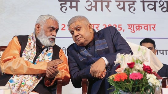 Former vice president Jagdeep Dhankar, right, and RSS leader Manmohan Vaidya during the release of his book titled 'Hum Aur Yeh Vishwa'. (PTI)