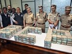 Bengaluru City Police Commissioner Seemanth Kumar Singh and other senior police officials pose for a picture with the recovered cash worth.