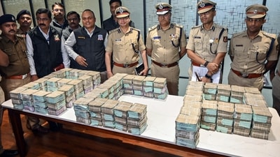 Bengaluru City Police Commissioner Seemanth Kumar Singh and other senior police officials pose for a picture with the recovered cash worth. Bengaluru City Police Commissioner Seemanth Kumar Singh and other senior police officials pose for a picture with the recovered cash worth.