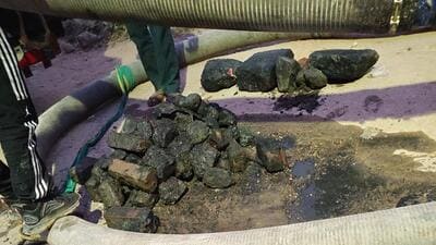 An MCG team found bricks, stones and other solid waste stuffed inside a manhole, raising suspicion that someone had intentionally attempted to block the sewer line. (HT photo) An MCG team found bricks, stones and other solid waste stuffed inside a manhole, raising suspicion that someone had intentionally attempted to block the sewer line. (HT photo)