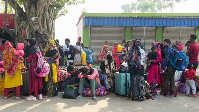Bangladeshi nationals, who allegedly entered Indian territory illegally, await to return to their homeland following the implementation of the special intensive revision (SIR) of electoral rolls, at Hakimpur checkpost in North 24 Parganas district, West Bengal, Saturday, Nov. 22, 2025. (PTI) Bangladeshi nationals, who allegedly entered Indian territory illegally, await to return to their homeland following the implementation of the special intensive revision (SIR) of electoral rolls, at Hakimpur checkpost in North 24 Parganas district, West Bengal, Saturday, Nov. 22, 2025. (PTI)
