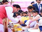 Uttarakhand chief minister Pushkar Singh Dhami participates in a ceremony with young children during the five-day religious and social event at Jeevandeep Ashram in Roorkee. Uttarakhand chief minister Pushkar Singh Dhami participates in a ceremony with young children during the five-day religious and social event at Jeevandeep Ashram in Roorkee.
