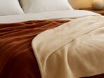 Soft fleece blankets spread across a bed create easy warmth and set the mood for slow winter evenings at home.(AI generated)