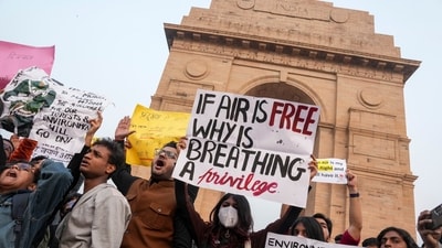 People raise slogans during a protest against worsening air quality in the national capital, at the India Gate, in New Delhi. (PTI) People raise slogans during a protest against worsening air quality in the national capital, at the India Gate, in New Delhi. (PTI)