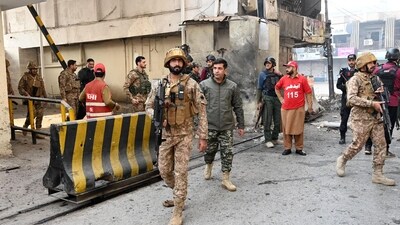 Army personnel inspect the suicide attack site outside the border force headquarters in Peshawar (AFP) Army personnel inspect the suicide attack site outside the border force headquarters in Peshawar (AFP)