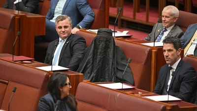 Senators react as One Nation leader Pauline Hanson wears a burqa in the Senate chamber at Parliament House in Canberra, Australia, November 24, 2025. (Reuters)