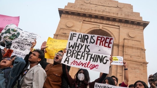 People raise slogans during a protest against worsening air quality in the national capital, at the India Gate, in New Delhi. (PTI)