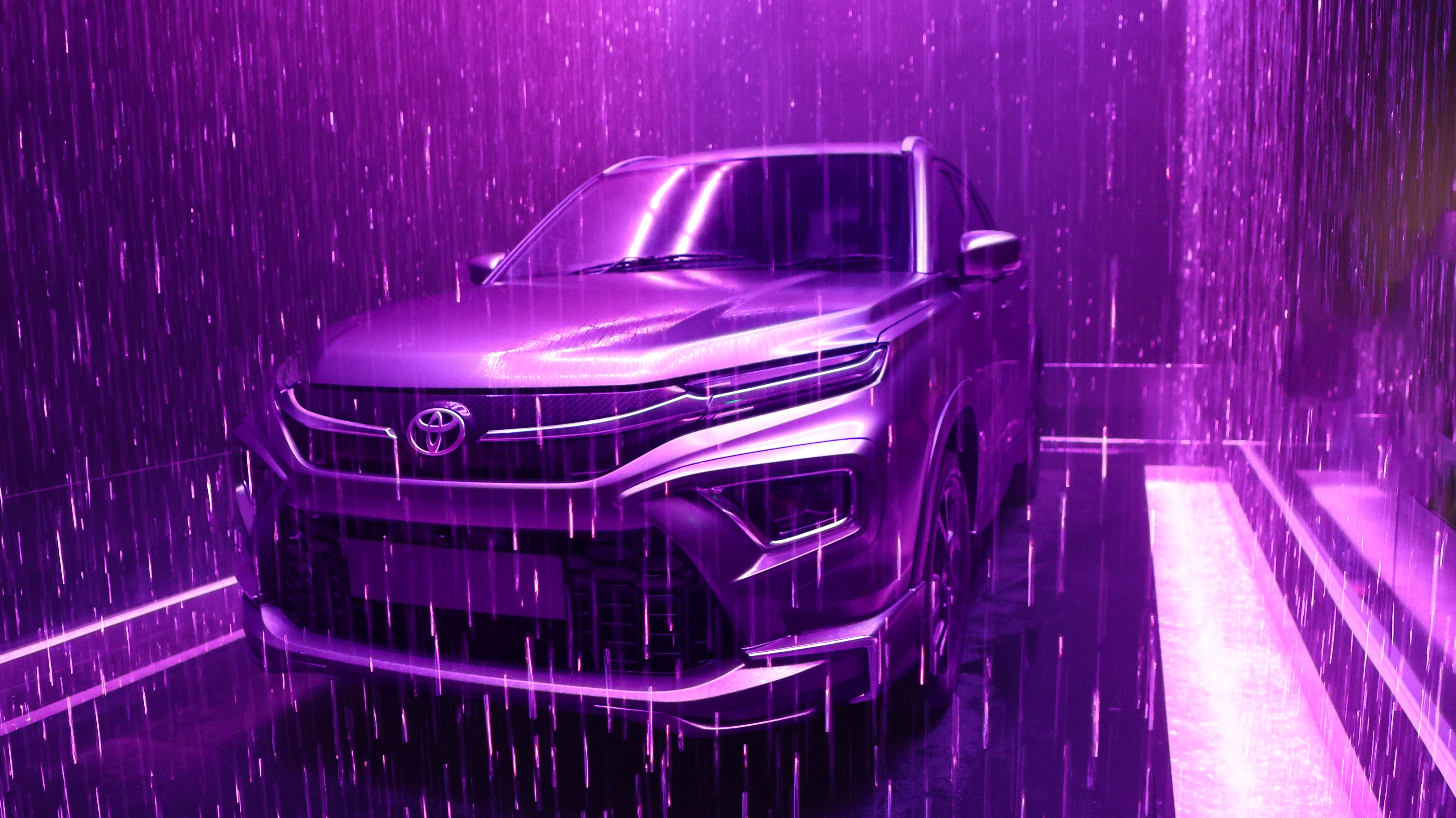 The space includes a centrepiece installation featuring a satin-draped vehicle surrounded by a cascading water curtain The space includes a centrepiece installation featuring a satin-draped vehicle surrounded by a cascading water curtain