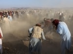 Afghan mourners and relatives of victims cover the graves with soil during a mass burial ceremony for nine children and one woman who were killed by a Pakistan air strike, in the Gurbuz district of Khost Province on November 25, 2025. 