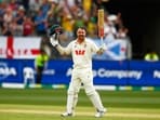 Travis Head celebrates his century on day two of the first Ashes cricket test match between Australia and England.