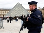 French CRS riot police officers were seen patrolling near the glass Pyramid of the Louvre Museum, after French police arrested suspects in the Louvre heist case, in Paris