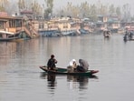 People enjoy a Shikara ride on a cold foggy morning at Dal Lake, in Srinagar on Monday. (ANI)