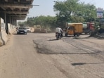 The 100 feet arterial road has since deteriorated severely, with heavy monsoon waterlogging adding to commuter woes. (HT) The 100 feet arterial road has since deteriorated severely, with heavy monsoon waterlogging adding to commuter woes. (HT)