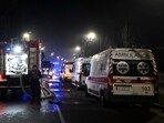 A Ukrainian law enforcement officer stands next to ambulances and a fire truck parked at the site of an air attack in Kyiv on November 25, 202. A Ukrainian law enforcement officer stands next to ambulances and a fire truck parked at the site of an air attack in Kyiv on November 25, 202.
