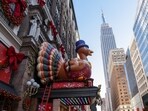 Decorations for Macy's Thanksgiving Day Parade and the holidays are installed outside Macy's Herald Square, as the Empire State Building rises in the background, in New York City, U.S., November 24, 2025. REUTERS/Kylie Cooper(REUTERS)