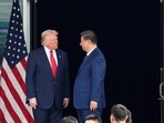 US President Donald Trump and Chinese President Xi Jinping talk as they leave after a bilateral meeting in Busan, South Korea, in October 