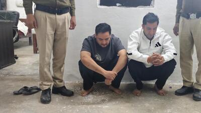 The arrested two suspects in police custody. The arrested two suspects in police custody.