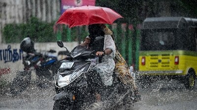 Motorists holding umbrellas ride along a street amid heavy rains in Chennai. (Image for representation/AFP) Motorists holding umbrellas ride along a street amid heavy rains in Chennai. (Image for representation/AFP)