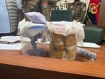 Drugs and weapons recovered by the BSF near Pak border on Tuesday. (HT Photo) Drugs and weapons recovered by the BSF near Pak border on Tuesday. (HT Photo)