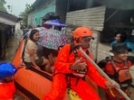 In this photo released by the Indonesian National Search and Rescue Agency (BASARNAS), rescuers on a rubber boat evacuate residents from their flooded home in North Sumatra province, Indonesia Tuesday, Nov. 25, 2025. (BASARNAS via AP)