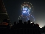 People watch a 'drone show' organised at Anandpur Sahib dedicated to the 350th martyrdom day in Rupnagar on Monday. (ANI) People watch a 'drone show' organised at Anandpur Sahib dedicated to the 350th martyrdom day in Rupnagar on Monday. (ANI)