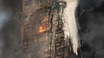 Smoke rises while flames burn bamboo scaffolding on a building at Wang Fuk Court housing estate, in Tai Po, Hong Kong. (REUTERS)