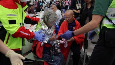 A woman receives medical attention at a temporary shelter, after a fire started across multiple buildings at Wang Fuk Court housing estate, in Tai Po. (REUTERS)