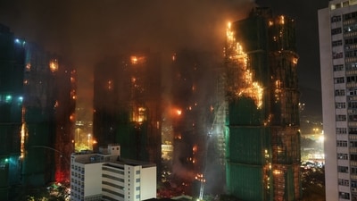 Firefighters work to extinguish flames, as fire burns bamboo scaffolding across multiple buildings at Wang Fuk Court housing estate, in Tai Po, Hong Kong, China, November 26, 2025. REUTERS/Tyrone Siu (REUTERS)