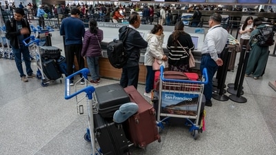 Travelers at San Francisco International Airport (SFO) in San Francisco, California, US, on Tuesday, Nov. 25, 2025. The US faces a hodgepodge of bad weather this week, from chills in Chicago and New York to thunderstorms across Texas, raising the threat of travel delays for the country's busy Thanksgiving holiday. Photographer: David Paul Morris/Bloomberg (Bloomberg) Travelers at San Francisco International Airport (SFO) in San Francisco, California, US, on Tuesday, Nov. 25, 2025. The US faces a hodgepodge of bad weather this week, from chills in Chicago and New York to thunderstorms across Texas, raising the threat of travel delays for the country's busy Thanksgiving holiday. Photographer: David Paul Morris/Bloomberg (Bloomberg)