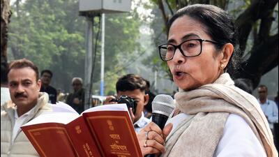 West Bengal Chief Minister Mamata Banerjee reads through the Constitution of India during the celebration of Constitution Day near B.R. Ambedkar statue, in Kolkata on Wednesday. (ANI) West Bengal Chief Minister Mamata Banerjee reads through the Constitution of India during the celebration of Constitution Day near B.R. Ambedkar statue, in Kolkata on Wednesday. (ANI)