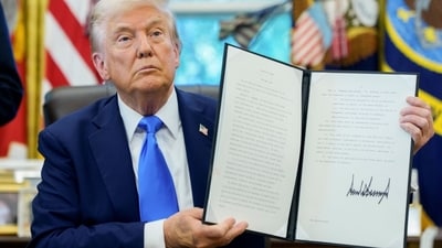 President Donald Trump holds a signed executive order in the Oval Office of the White House. President Donald Trump holds a signed executive order in the Oval Office of the White House.