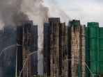 Firefighters work to extinguish a fire which broke out Wednesday at Wang Fuk Court, a residential estate in the Tai Po district of Hong Kong's New Territories, Thursday, Nov. 27, 2025. (AP Photo/Chan Long Hei)