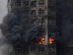 Thick smoke billows from the upper floors of a residential block at Wang Fuk Court housing estate during a major fire that engulfed bamboo scaffolding across multiple buildings, in Tai Po, Hong Kong.