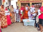 Voters show the enumeration forms given by a Booth Level Officer during the ongoing special intensive revision of electoral rolls in Bihar. Voters show the enumeration forms given by a Booth Level Officer during the ongoing special intensive revision of electoral rolls in Bihar.