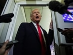 Donald Trump speaks to reporters aboard Air Force One during travel to Palm Beach, Florida