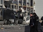 Law enforcement officers work at the site of the heavily damaged logistics hub of the Novus supermarket following Russian missiles and drones strikes in Kyiv on November 25, 2025, amid Russian invasion in Ukraine. (Photo by OLEKSII FILIPPOV / AFP)