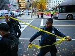 Police officers secure the area with crime scene tape after a shooting in downtown Washington, DC, on November 26, 2025. Two members of the National Guard were shot Wednesday just blocks from the White House, according to officials, as a spokesperson for Donald Trump said the president has been briefed on the "tragic situation." Police said they had detained a suspect