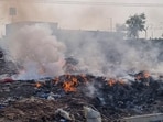 Waste seen on fire at an illegal dumping site in Narsinghpur industrial area in Gurugram on Thursday. (Parveen Kumar/HT)