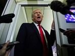 US President Donald Trump speaks to reporters aboard Air Force One 