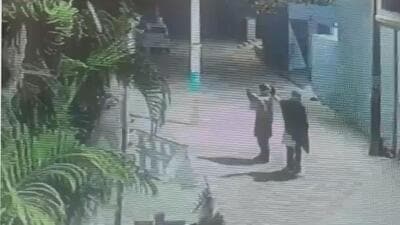 A CCTV grab of two masked men opening fire outside the house of Phagwara AAP leader Daljit Singh Raju around 1.15am on Thursday. A CCTV grab of two masked men opening fire outside the house of Phagwara AAP leader Daljit Singh Raju around 1.15am on Thursday.