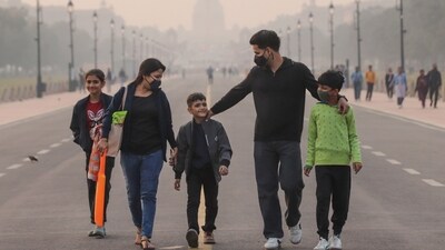 Gram it: To mask up or not? As Air Quality Index (AQI) remains in the ‘very poor’ category, here's how some visitors wear face masks while walking through smog near Rashtrapati Bhavan that's barely visible from the Kartavya Path. (Photo: Naveen Sharma/ANI )