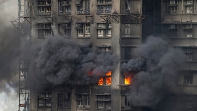 A fire can be seen at Wang Fuk Court, a residential estate in the Tai Po district of Hong Kong's New Territories. (AP) A fire can be seen at Wang Fuk Court, a residential estate in the Tai Po district of Hong Kong's New Territories. (AP)