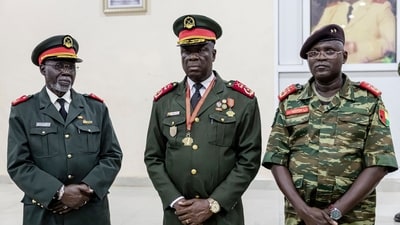 Guinea-Bissau Army General Horta N'Tam or Inta-A (centre) poses for a photo next to Advisor to High Military Commander Malam Camara (L) and Ad-hoc Secretary of the Military Command Samuel Fernandes during his swearing-in as the transition leader on November 27, 2025. (AFP) Guinea-Bissau Army General Horta N'Tam or Inta-A (centre) poses for a photo next to Advisor to High Military Commander Malam Camara (L) and Ad-hoc Secretary of the Military Command Samuel Fernandes during his swearing-in as the transition leader on November 27, 2025. (AFP)
