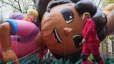 A volunteer passes the Nickelodeon's Dora balloon during the balloon inflation for the 99th Macy's Thanksgiving Day Parade (AP) A volunteer passes the Nickelodeon's Dora balloon during the balloon inflation for the 99th Macy's Thanksgiving Day Parade (AP)