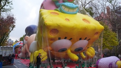 A volunteer takes a selfie with SpongeBob SquarePants and Gary balloon during the inflation for the 99th Macy's Thanksgiving Day Parade (AP) A volunteer takes a selfie with SpongeBob SquarePants and Gary balloon during the inflation for the 99th Macy's Thanksgiving Day Parade (AP)