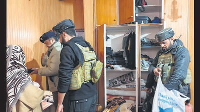 Police with CRPF personnel carry out a search at the residence of a person linked to banned Jamaat-e-Islami, in Pulwama,on Thursday. (PTI) Police with CRPF personnel carry out a search at the residence of a person linked to banned Jamaat-e-Islami, in Pulwama,on Thursday. (PTI)