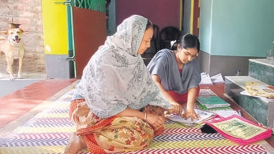 Sabeera Khatun, 42, a teacher and Booth Level Officer, works on SIR forms with her daughter Sahieena in Usthi, West Bengal. (HT PHOTO) Sabeera Khatun, 42, a teacher and Booth Level Officer, works on SIR forms with her daughter Sahieena in Usthi, West Bengal. (HT PHOTO)